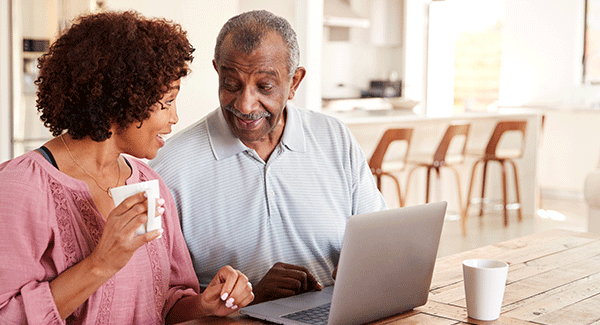 man and woman in fron t of a laptop